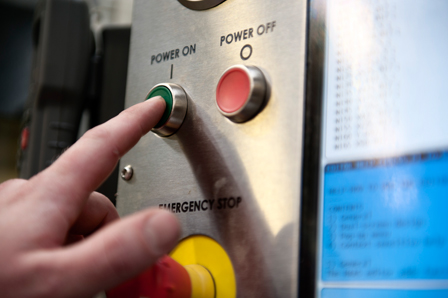 man pushing button on machine